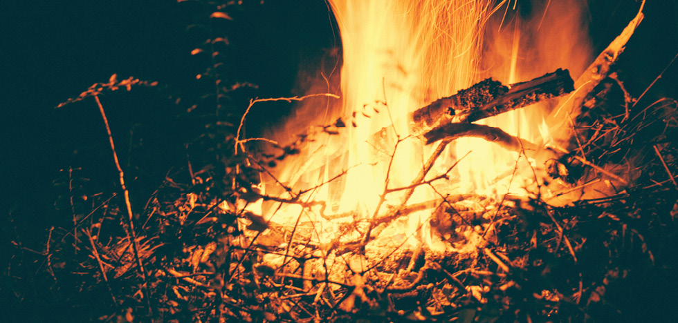 Burning twigs and sticks at night.